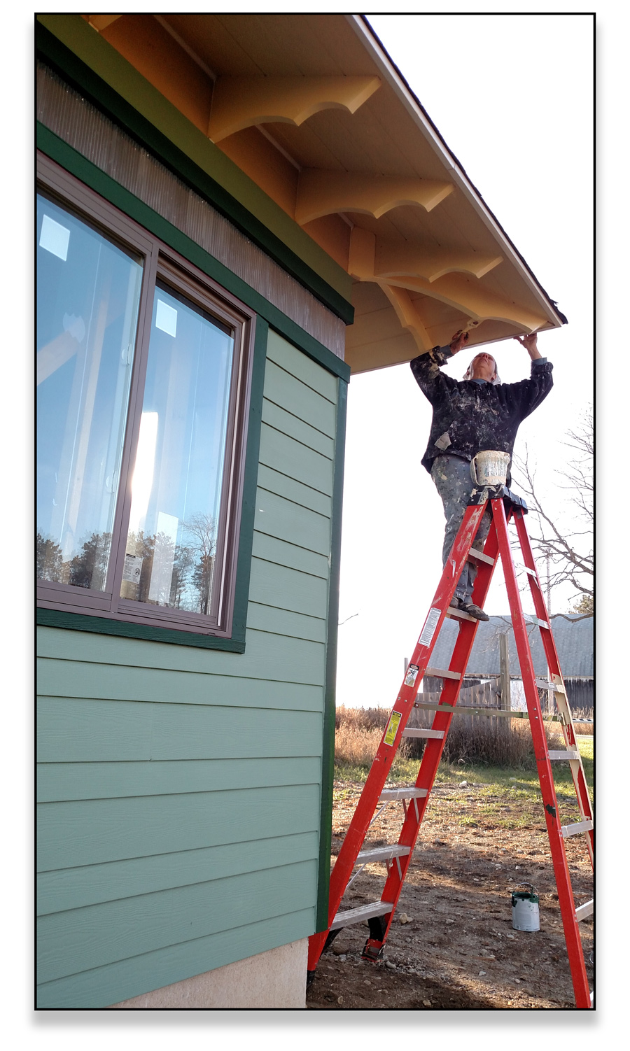 Trudi painting the rafter tails